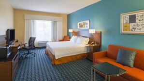 A hotel room with a bed, a desk with a TV, a chair, a sofa, and a small table. - Best Western Allentown Bethlehem Lehigh Valley Inn & Suites (Bethlehem)