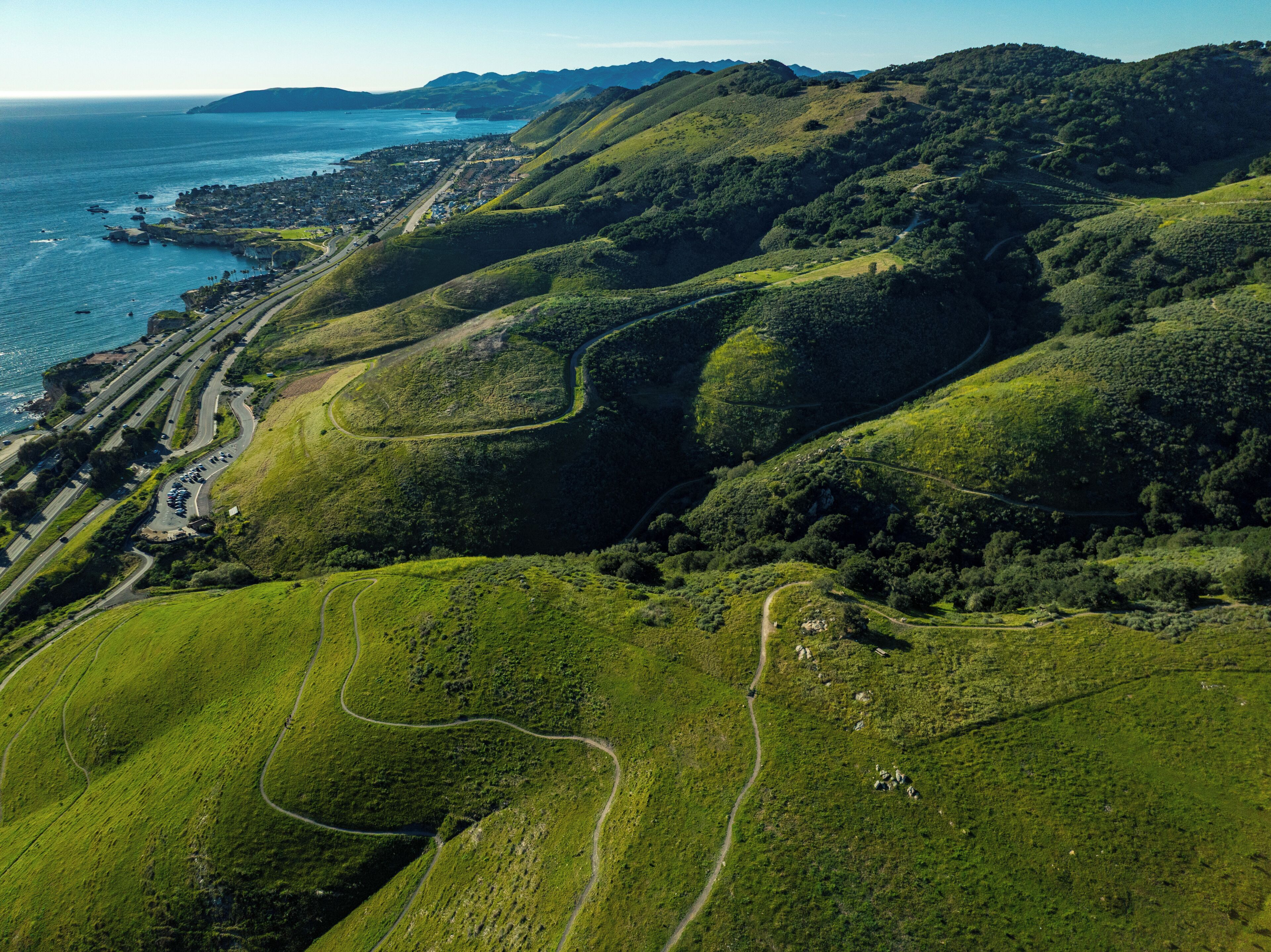 A coastal landscape with winding roads and a view of the sea.