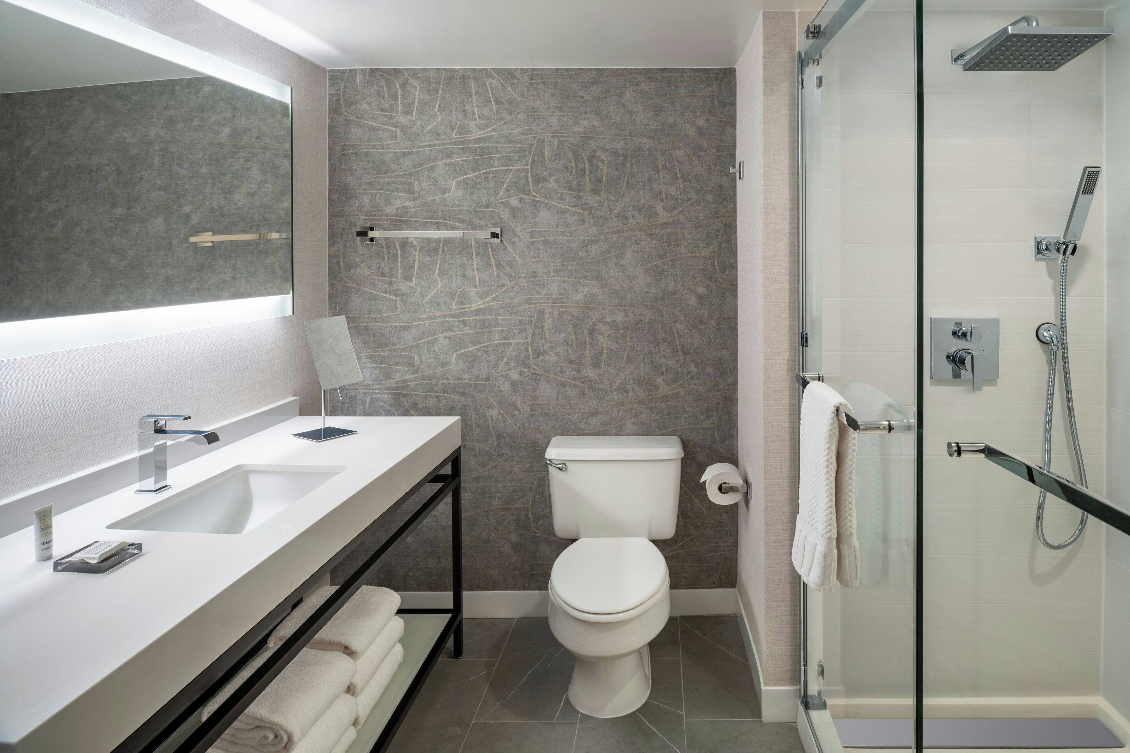 combined shower/bathtub, designer toiletries, hair dryer, bathrobes