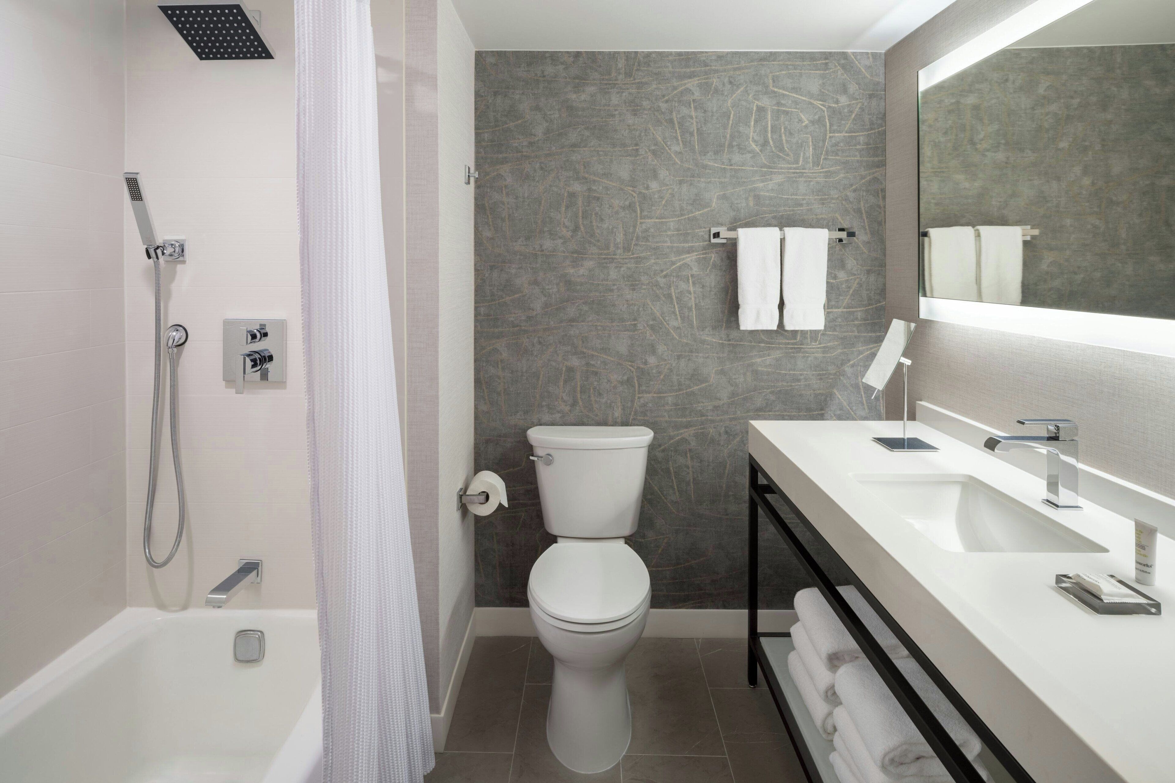 combined shower/bathtub, designer toiletries, hair dryer, bathrobes