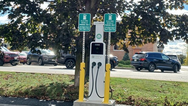 An electric vehicle charging station with two signs indicating it is for electric vehicles only. - Red Roof Inn Rochester - Henrietta (Henrietta)