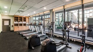 A gym with treadmills, elliptical machines, and weight equipment.