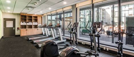 A gym with treadmills, elliptical machines, and weight equipment.