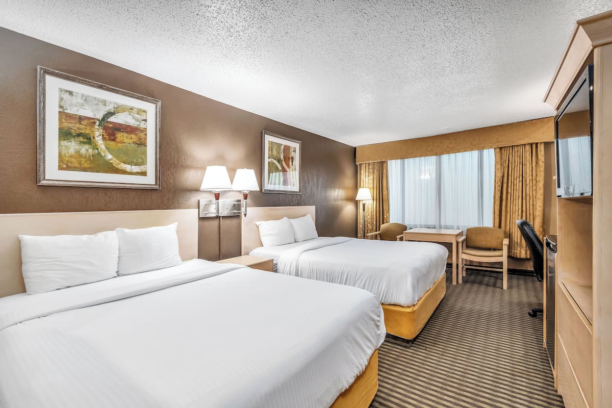 Premium bedding, desk, laptop workspace, blackout drapes