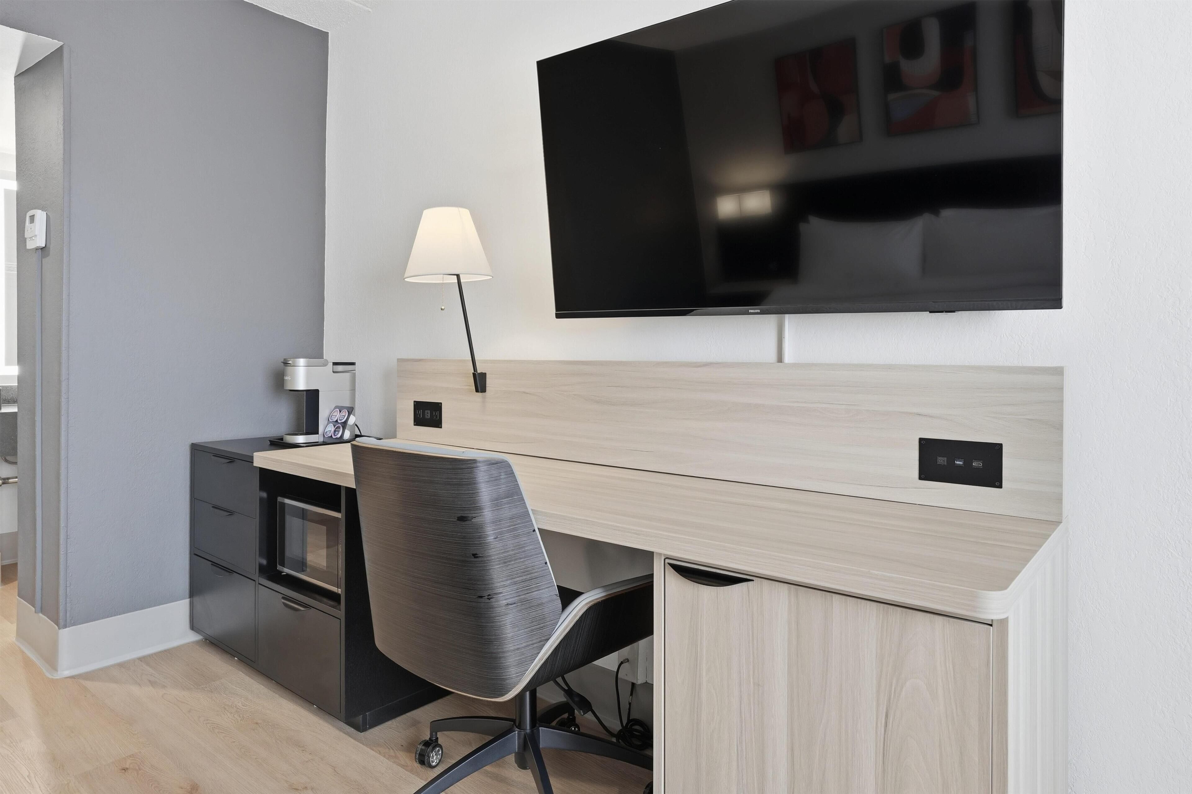 Premium bedding, desk, laptop workspace, blackout curtains