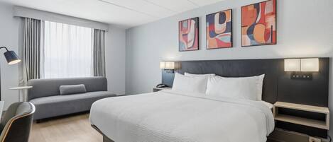 Premium bedding, desk, laptop workspace, blackout drapes