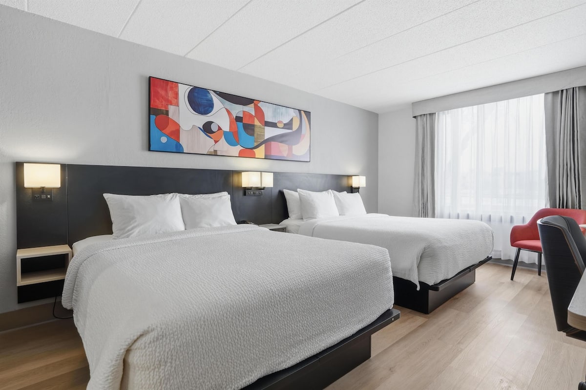 Premium bedding, desk, laptop workspace, blackout curtains