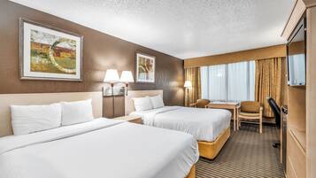 Premium bedding, desk, laptop workspace, blackout drapes