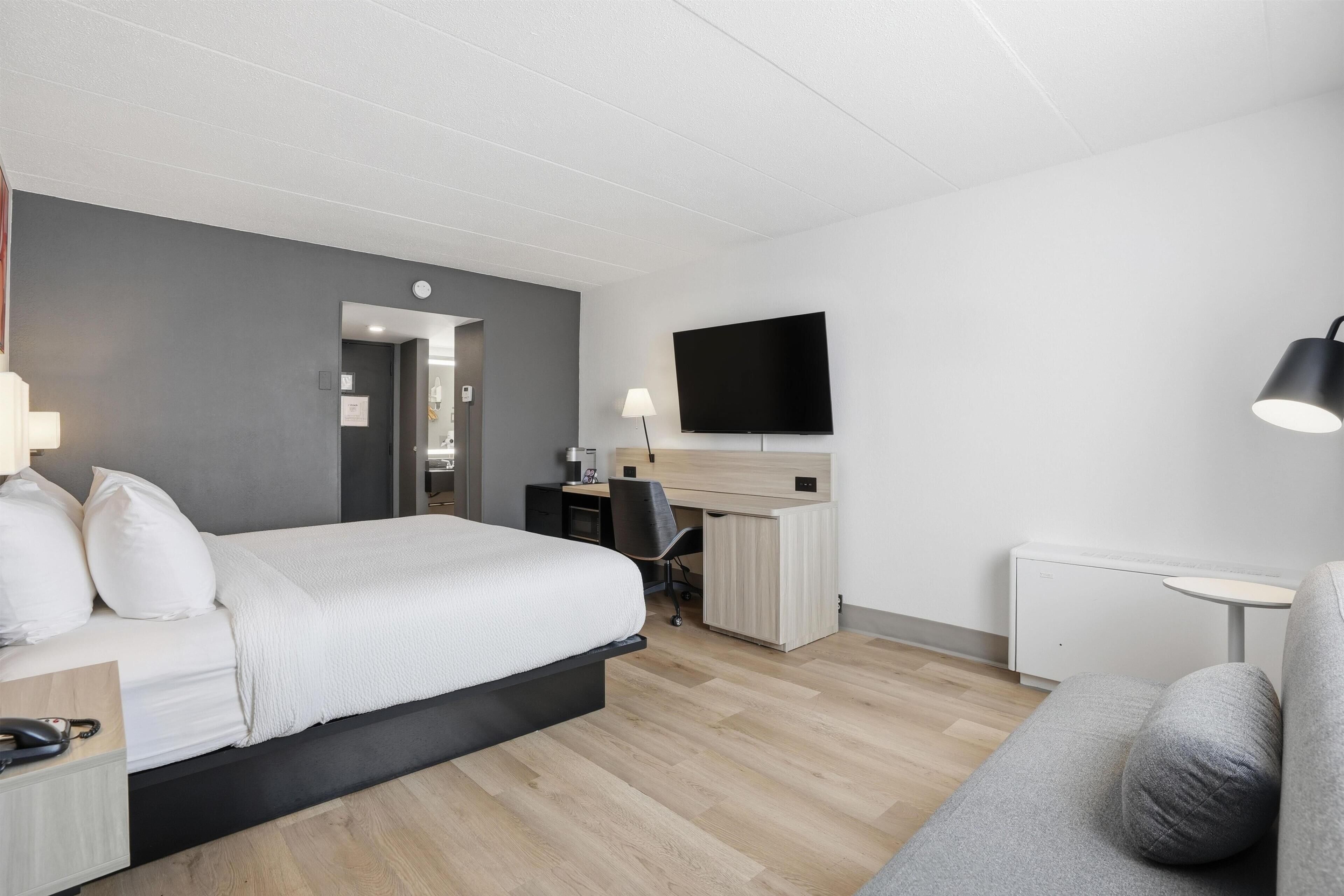 Premium bedding, desk, laptop workspace, blackout curtains