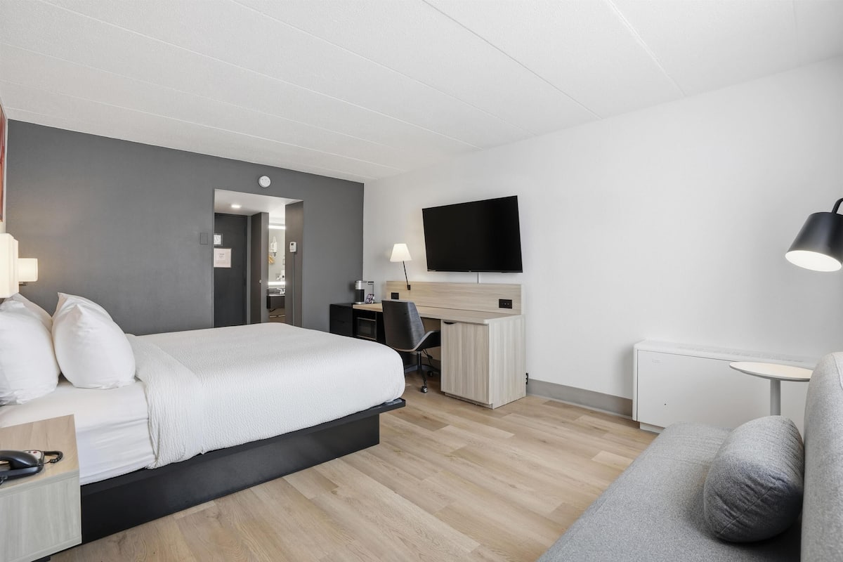 Premium bedding, desk, laptop workspace, blackout curtains