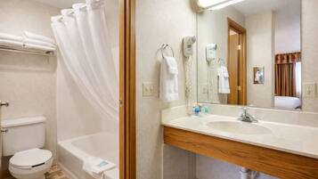 A bathroom with a bathtub, toilet, and sink.