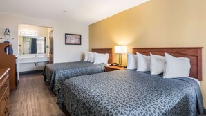 A hotel room with two beds, a dresser, a mirror, and a nightstand with a lamp. - Econo Lodge Inn & Suites Lodi - Wine Country Area (Lodi)