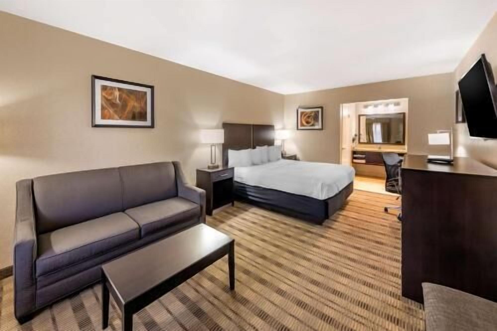 Premium bedding, desk, laptop workspace, iron/ironing board