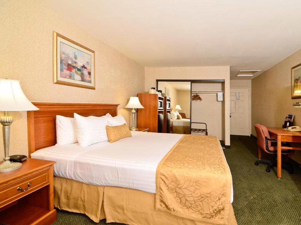 Premium bedding, desk, laptop workspace, iron/ironing board