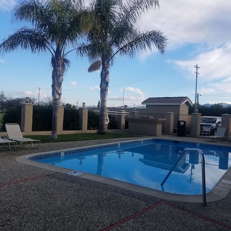 Seasonal outdoor pool, open 8:00 AM to 9:00 PM, sun loungers. SureStay Hotel by Best Western Hollister