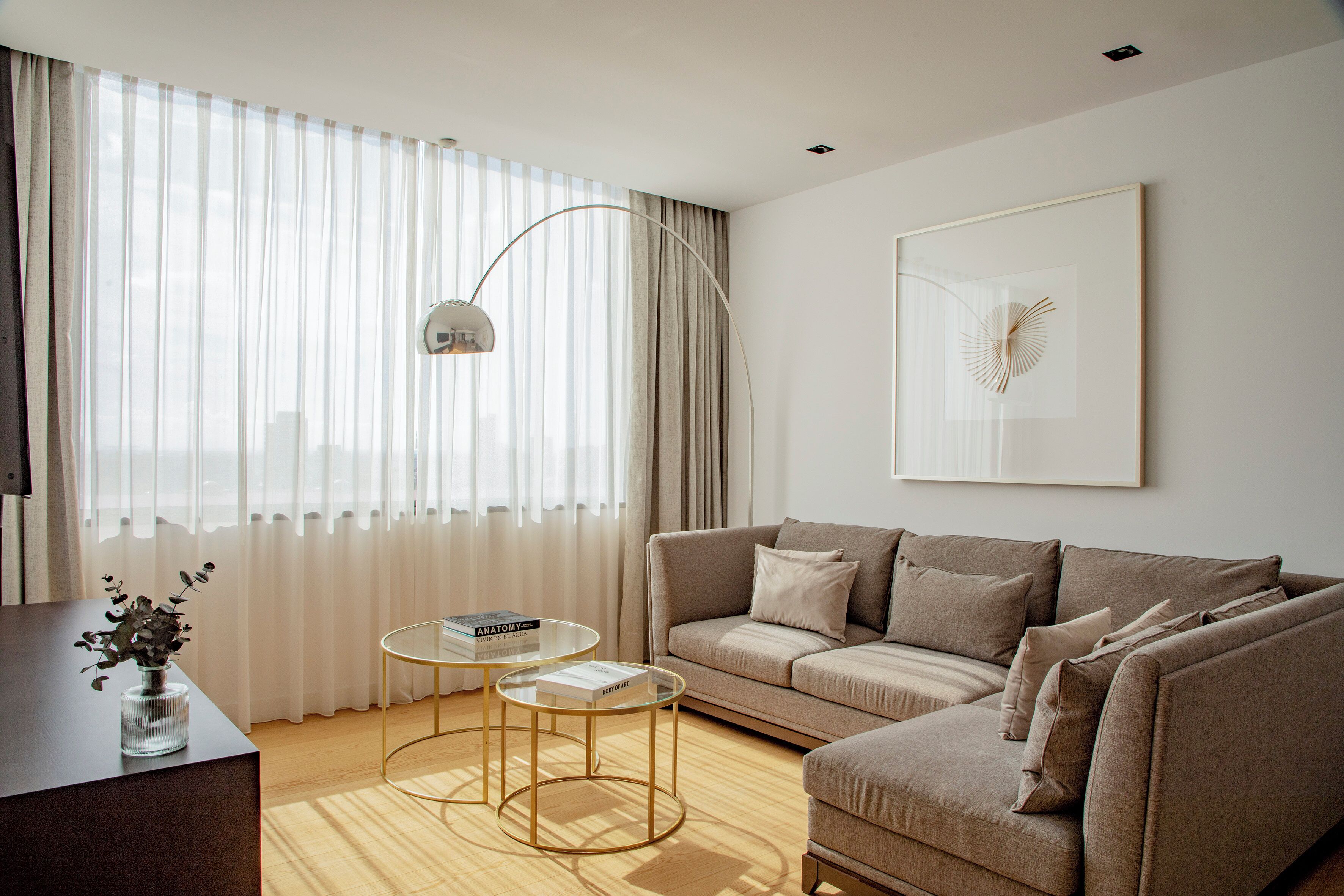 A modern living room with a sofa, a coffee table, and a floor lamp.