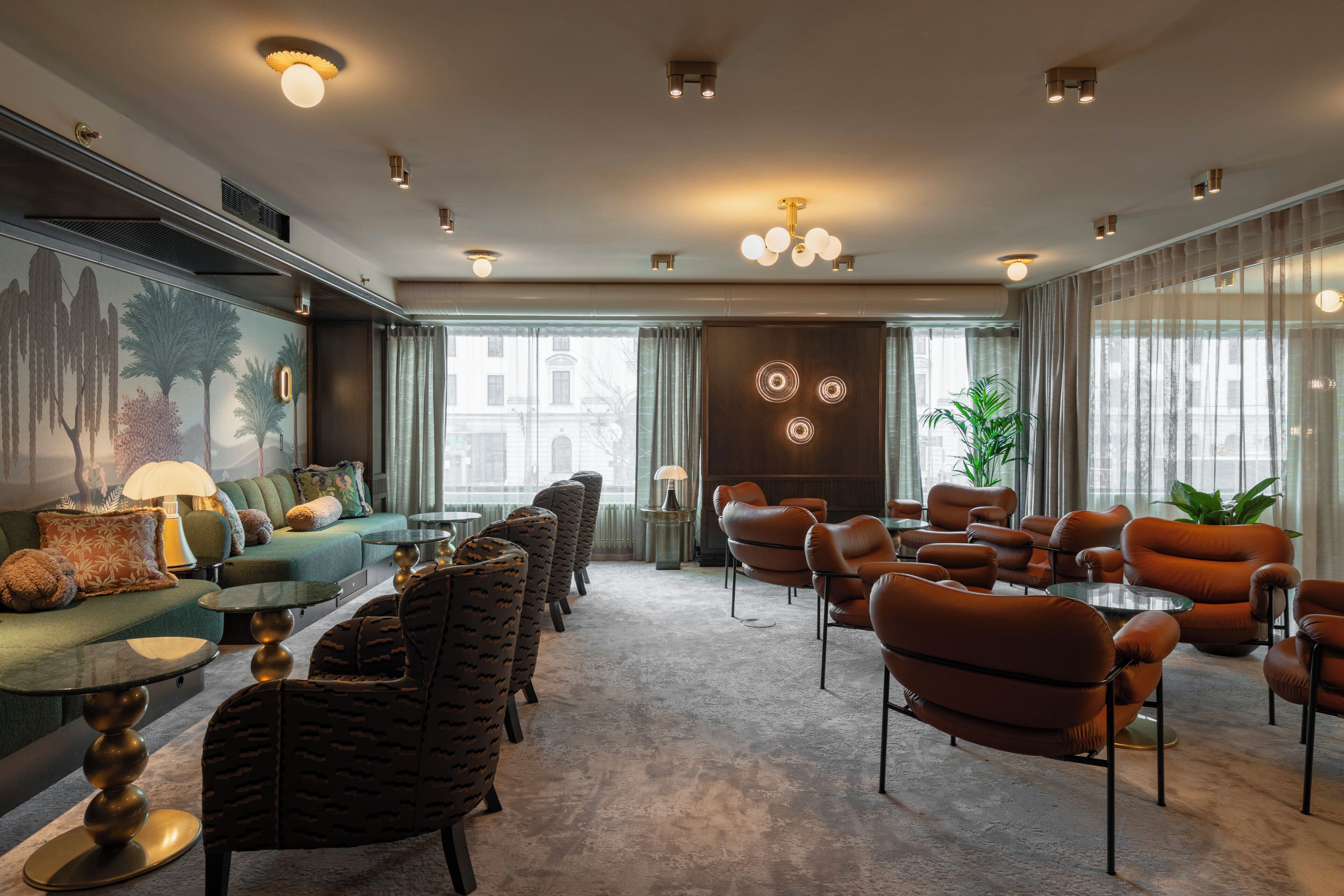 A modern lounge with a sofa, armchairs, and a coffee table.