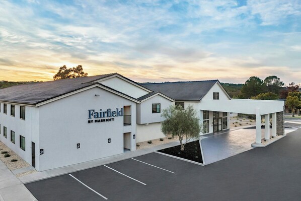 A Fairfield by Marriott hotel with a modern design, featuring a covered outdoor area and a parking lot.