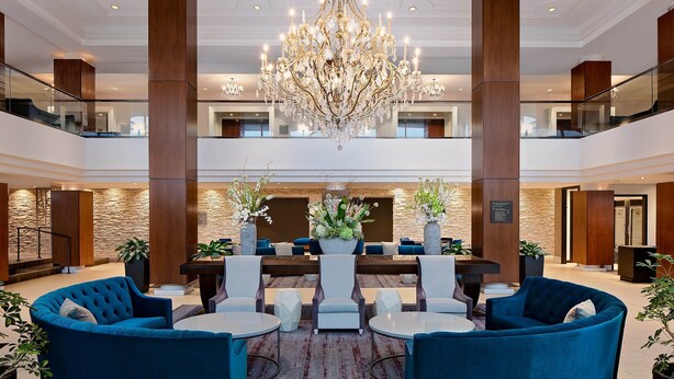 A spacious lobby with a grand chandelier, multiple seating areas, and a stone accent wall. - The Westin Governor Morris, Morristown (Morristown)