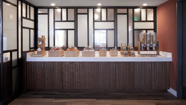 A modern kitchen with a wooden countertop, cabinets, and a built-in refrigerator. - Fairfield Inn & Suites by Marriott Camarillo (Camarillo)