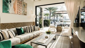 A modern living room with a sofa, coffee table, and artwork. - Cloister at The Boca Raton (Boca Raton)