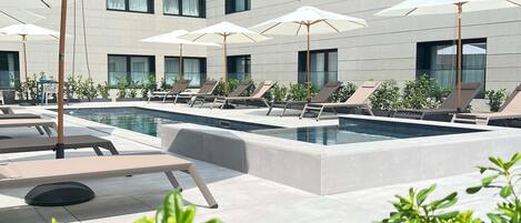 Seasonal outdoor pool, open 11:00 AM to 8:00 PM, pool umbrellas