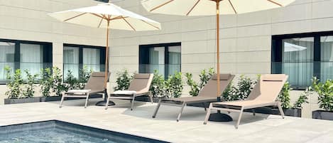 Seasonal outdoor pool, open 11:00 AM to 7:00 PM, pool umbrellas