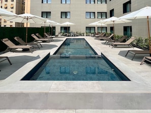 Seasonal outdoor pool, open 11:00 AM to 8:00 PM, pool umbrellas