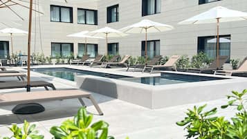 Seasonal outdoor pool, open 11:00 AM to 7:00 PM, pool umbrellas