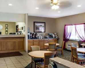 A hotel lobby with a reception desk, a coffee station, and seating area with tables and chairs. - Comfort Inn Jamestown South (Jamestown)