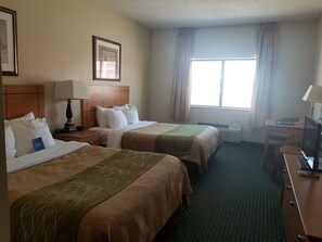 A hotel room with two beds, a desk, a chair, a lamp, a picture on the wall, and a window with curtains. - Comfort Inn Jamestown South (Jamestown)
