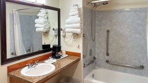A bathroom with a sink, mirror, towel rack, shower, and grab bars. - Econo Lodge Edmonds North Seattle (Edmonds)
