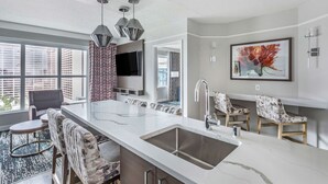 A modern kitchen with a large island, stainless steel sink, and pendant lighting. - Hilton Grand Vacations Club Flamingo Las Vegas (Las Vegas)