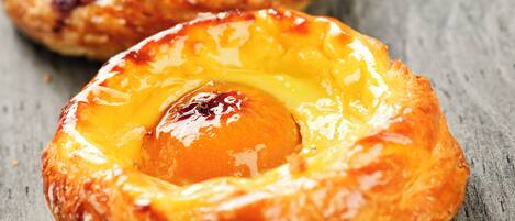 Three pastries on a wooden surface.