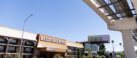 A multi-story building with a sign reading "Mardi Gras Hotel" and the number 3500.