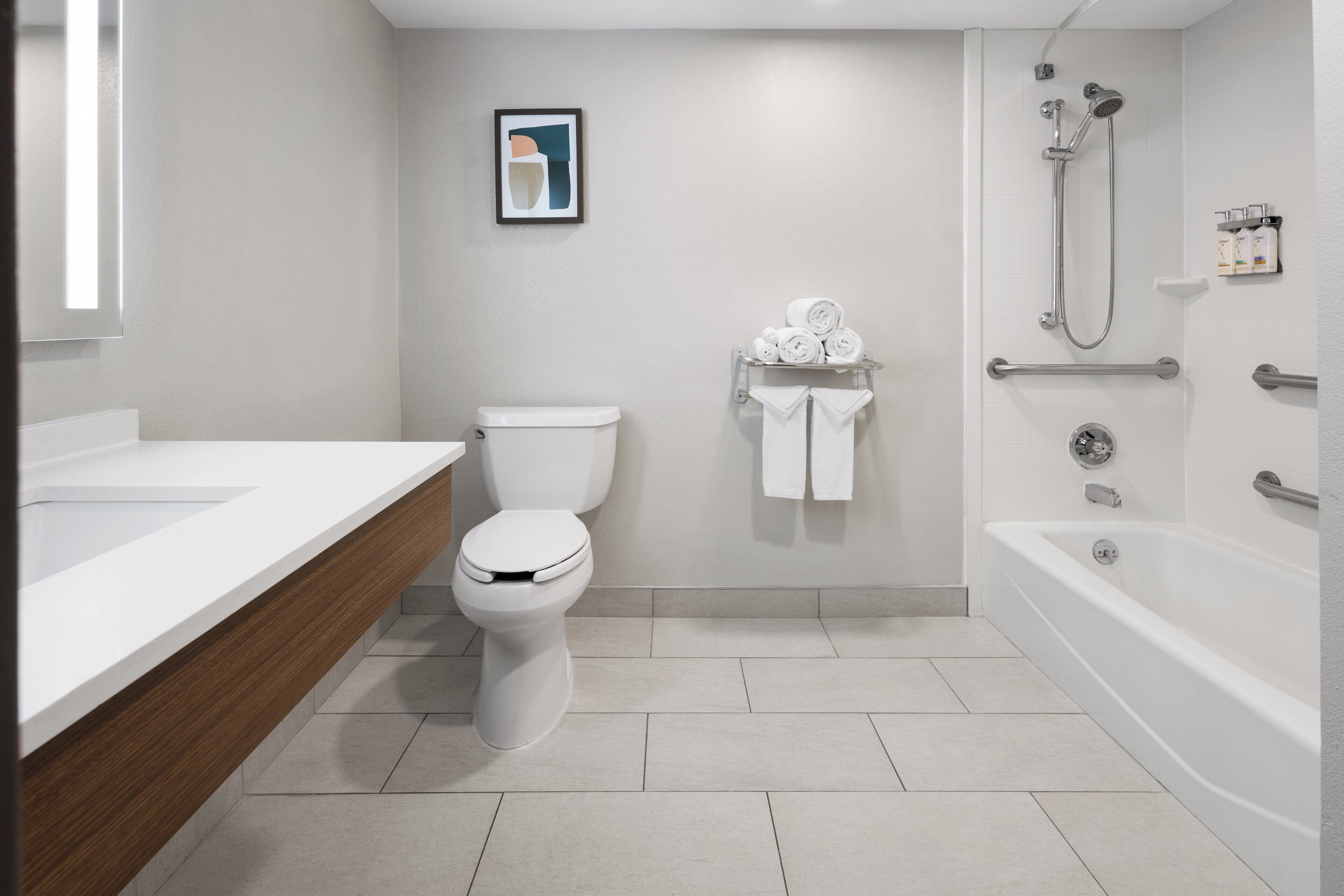 A modern bathroom with a toilet, sink, and bathtub.