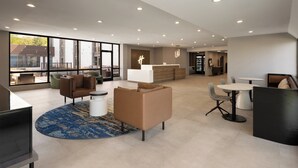 A spacious lobby with a reception desk, seating areas, and large windows offering views of the outside. - Holiday Inn Roanoke-Tanglewood-Rt 419&i581 by IHG (Roanoke)