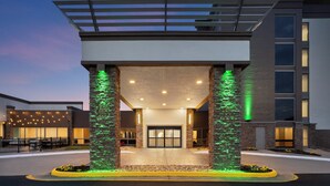 A hotel entrance with a covered walkway, stone pillars, and a glass door. - Holiday Inn Roanoke-Tanglewood-Rt 419&i581 by IHG (Roanoke)