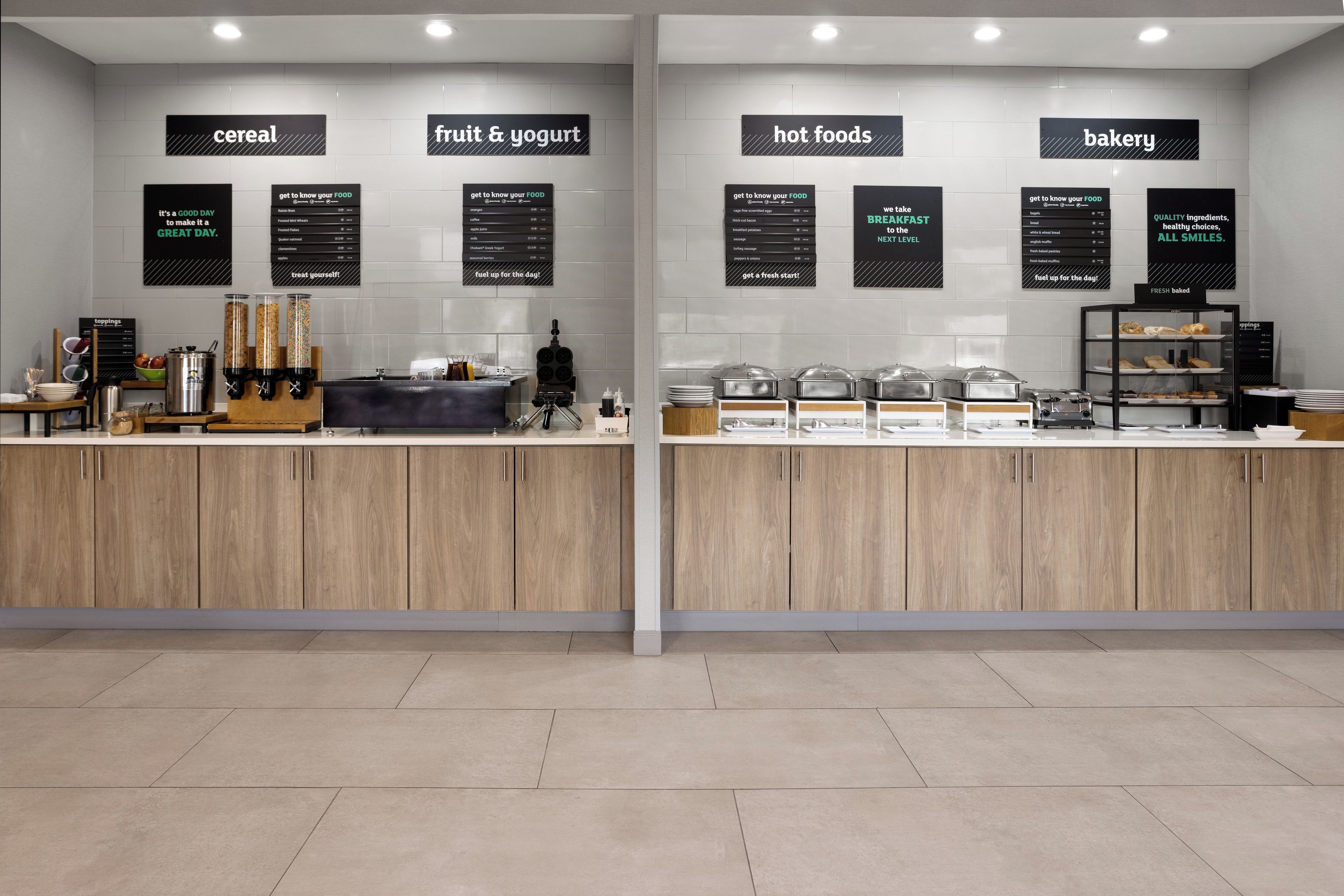 A breakfast bar with sections labeled 'cereal', 'fruit & yogurt', 'hot foods', and 'bakery'.
