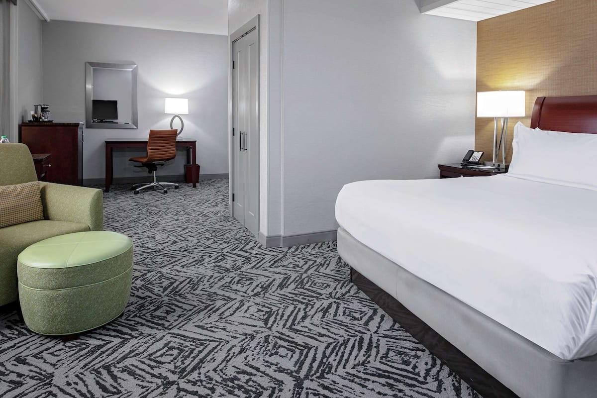 Premium bedding, desk, laptop workspace, iron/ironing board