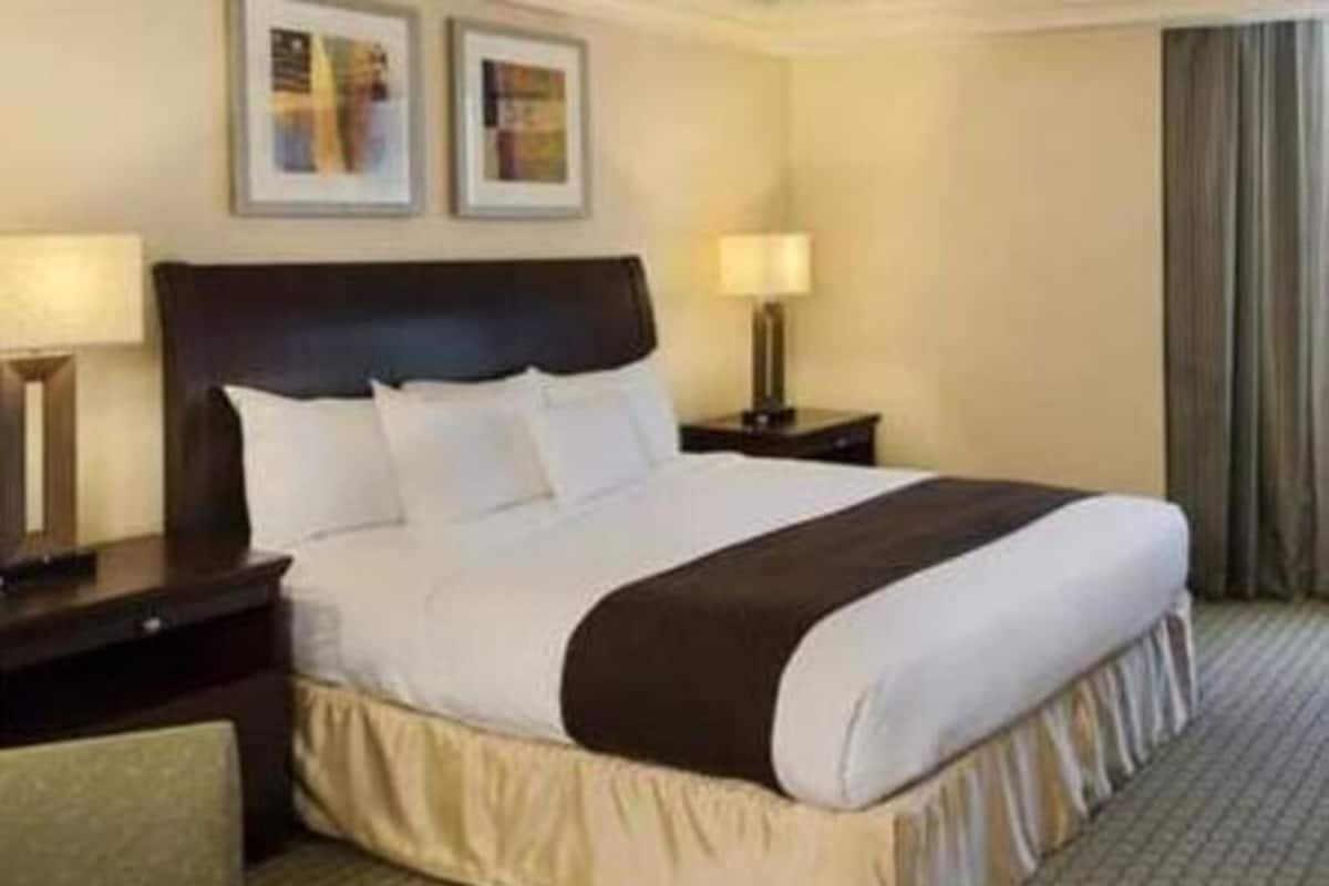 Premium bedding, desk, laptop workspace, iron/ironing board