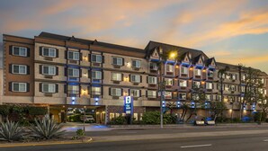 A multi-story hotel with a brick facade, multiple balconies, and a sign indicating it is a Best Western property. - Best Western Airpark Hotel - LAX Airport LA  Stadium (Inglewood)