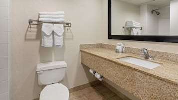 A bathroom with a toilet, sink, and towel rack.