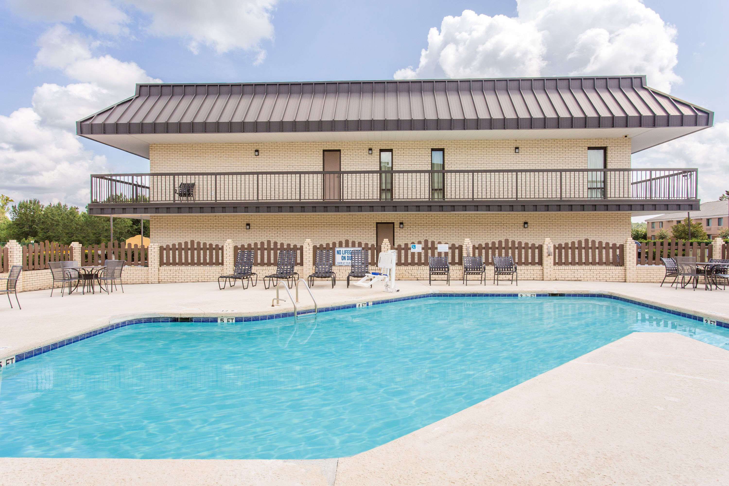 A two-story building with a swimming pool in front.