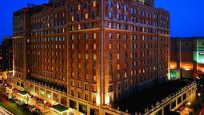 A multi-story hotel with a prominent sign on the top. - The Peabody Memphis (Memphis)