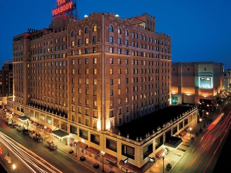 A large, multi-story hotel with a prominent neon sign on the roof.