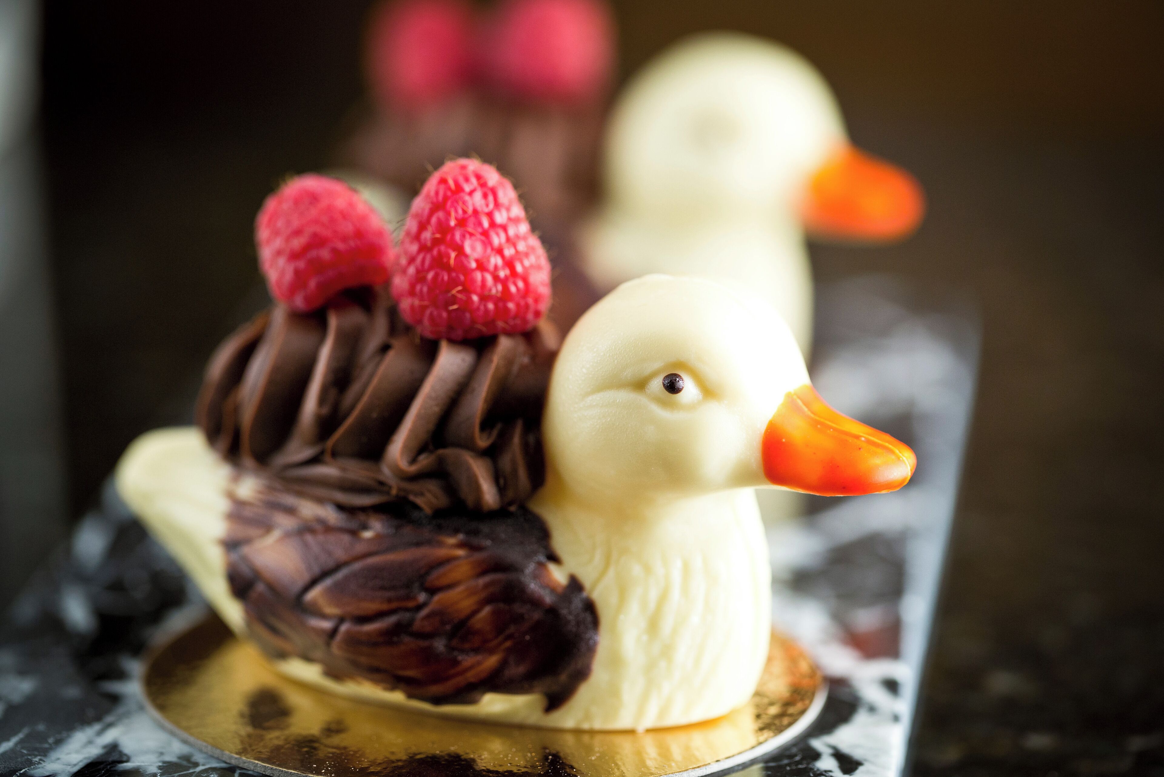 A dessert with a chocolate and strawberry decoration on a cake.