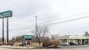 Welcome to Quality Inn & Suites, surrounded by lush gardens and a convenient parking area.