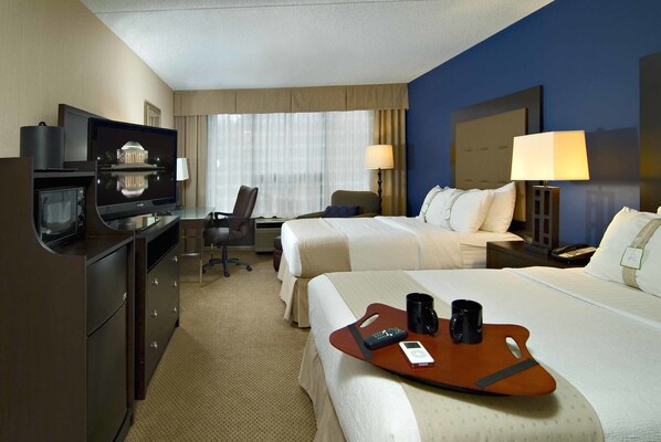 A hotel room with two beds, a desk, a television, and a minibar. - Holiday Inn Washington DC-Greenbelt MD by IHG (Greenbelt)