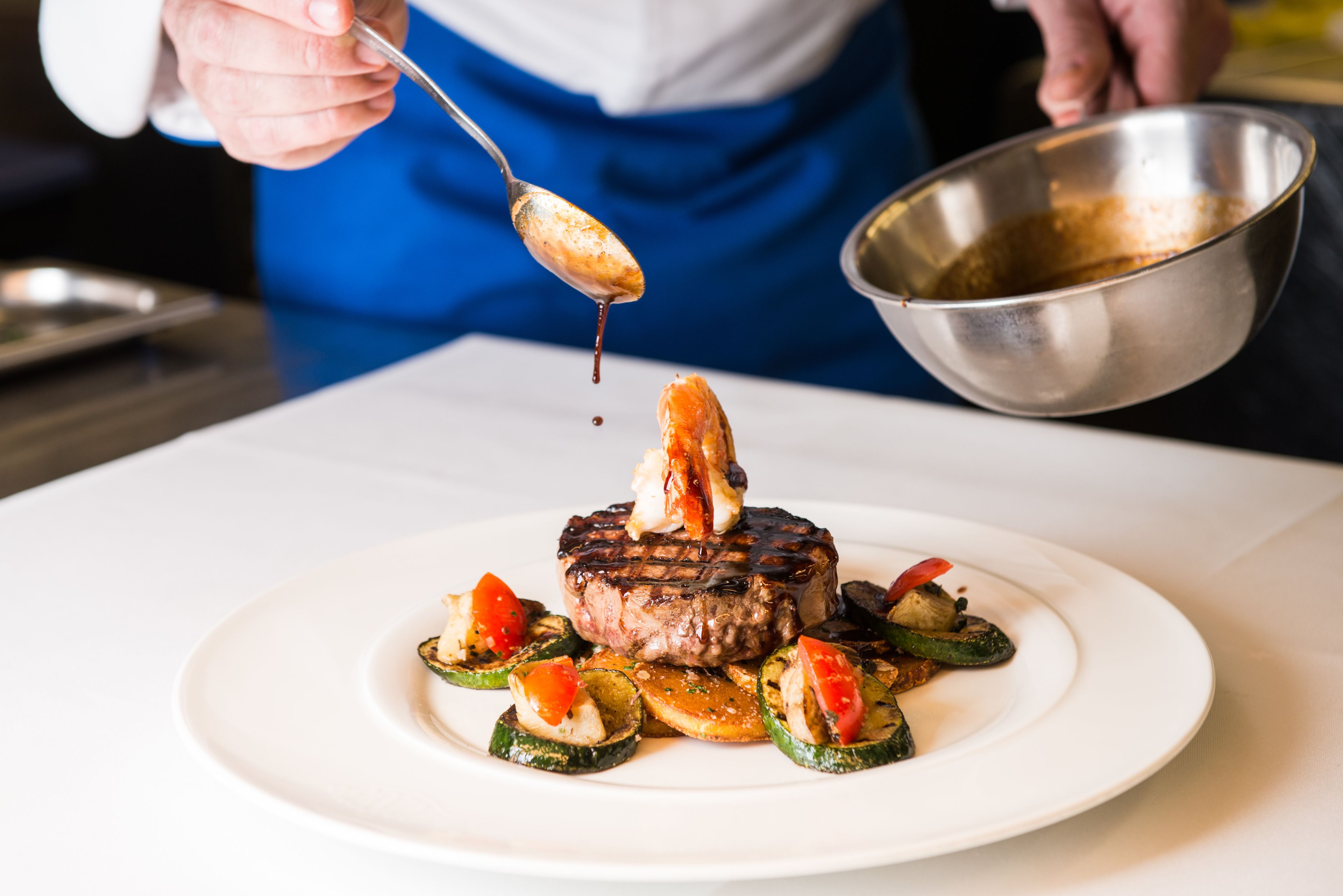 A steak with vegetables on a plate.